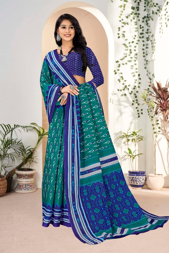 Elegant pine green and blue cotton saree with handloom craftsmanship and traditional tribal detail.