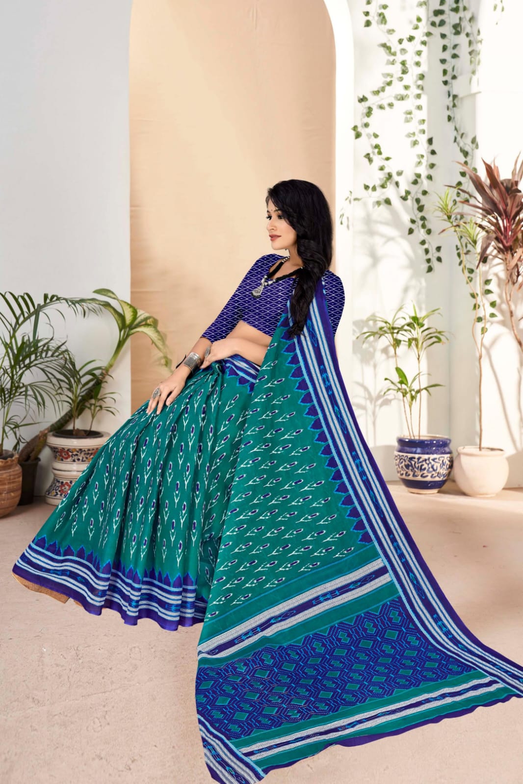 Beautiful handloom cotton saree in pine green and blue, featuring intricate tribal patterns.