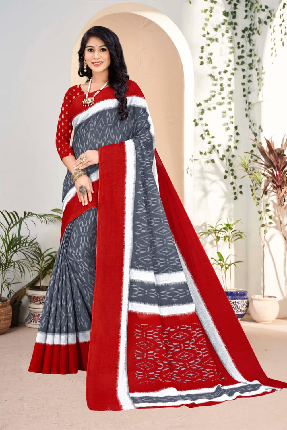 Traditional red cotton saree featuring intricate tribal art, ideal for cultural celebrations.