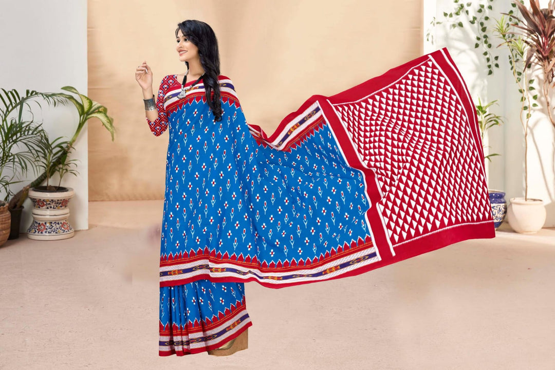 Striking blue and red handloom cotton saree with intricate tribal designs for festive occasions.