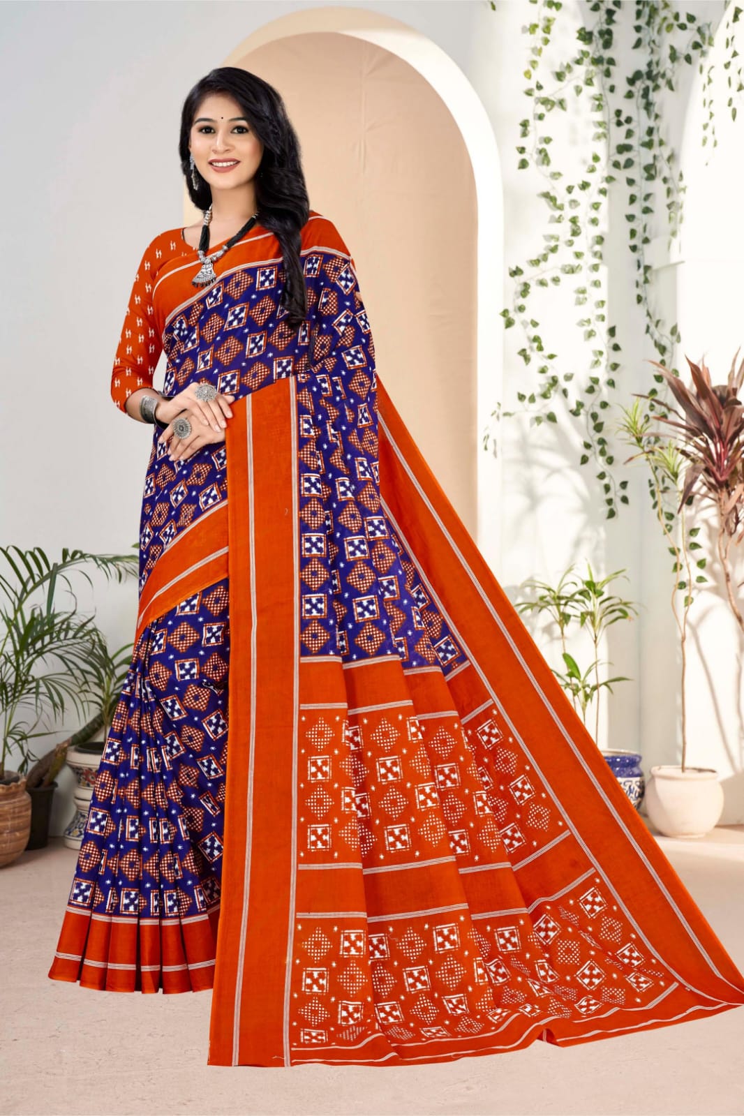 Midnight blue and orange handloom saree featuring bold tribal embellishments, perfect for ethnic wear.