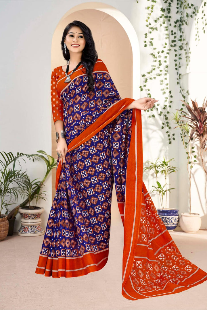 Stunning midnight blue and orange handloom cotton saree with tribal embellishments, perfect for cultural events.