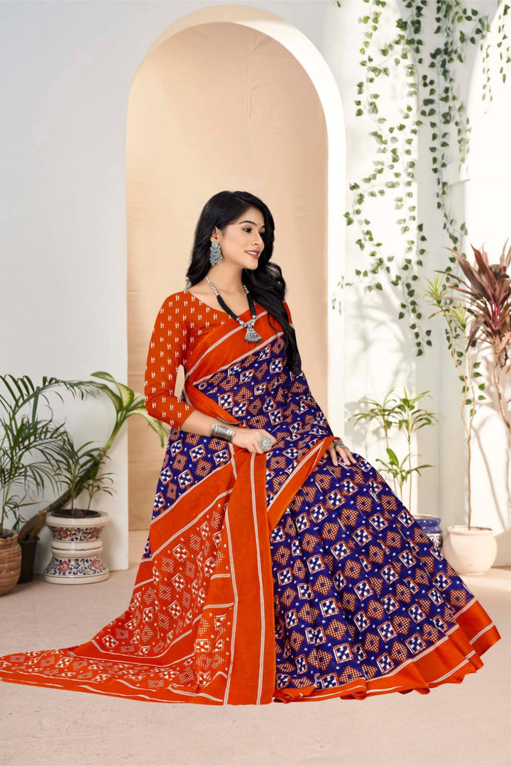 Traditional midnight blue and orange saree in handloom cotton, adorned with intricate tribal patterns.