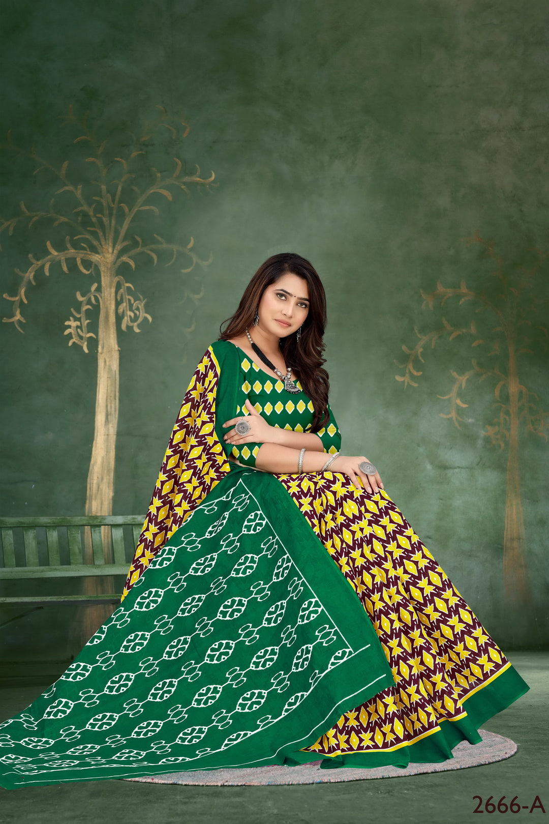 Traditional green handloom cotton saree featuring beautiful tribal patterns, perfect for festive wear.