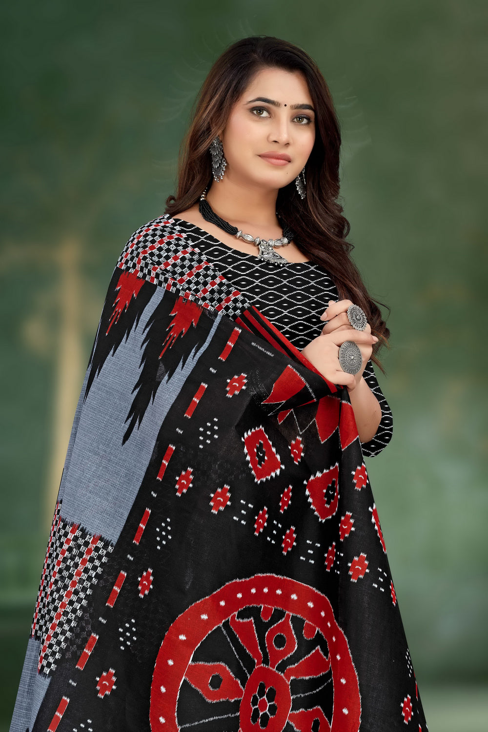 Elegant grey and black saree made from handloom cotton, featuring intricate tribal motifs for a traditional look.