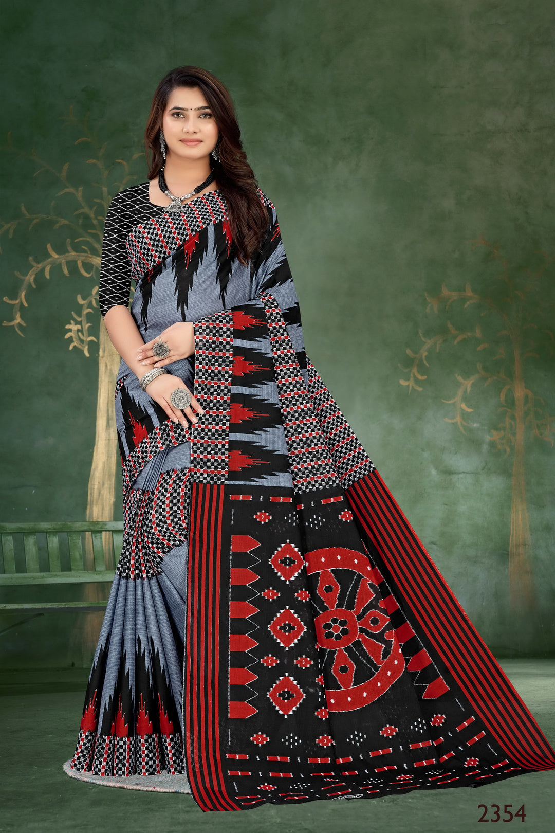 Sophisticated grey and black handloom cotton saree with tribal motifs, perfect for casual and festive wear.