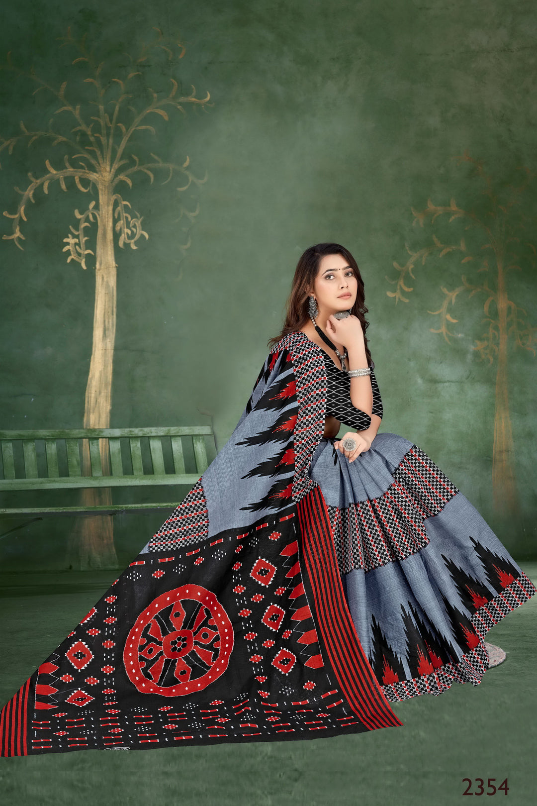 Traditional grey and black saree with unique tribal motifs, ideal for weddings and festive occasions.