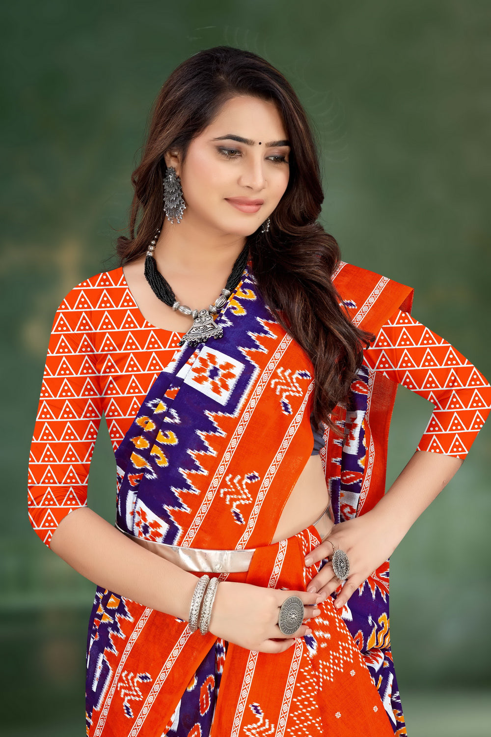 Stunning orange and blue handloom saree featuring detailed tribal designs, ideal for Indian weddings and celebrations.