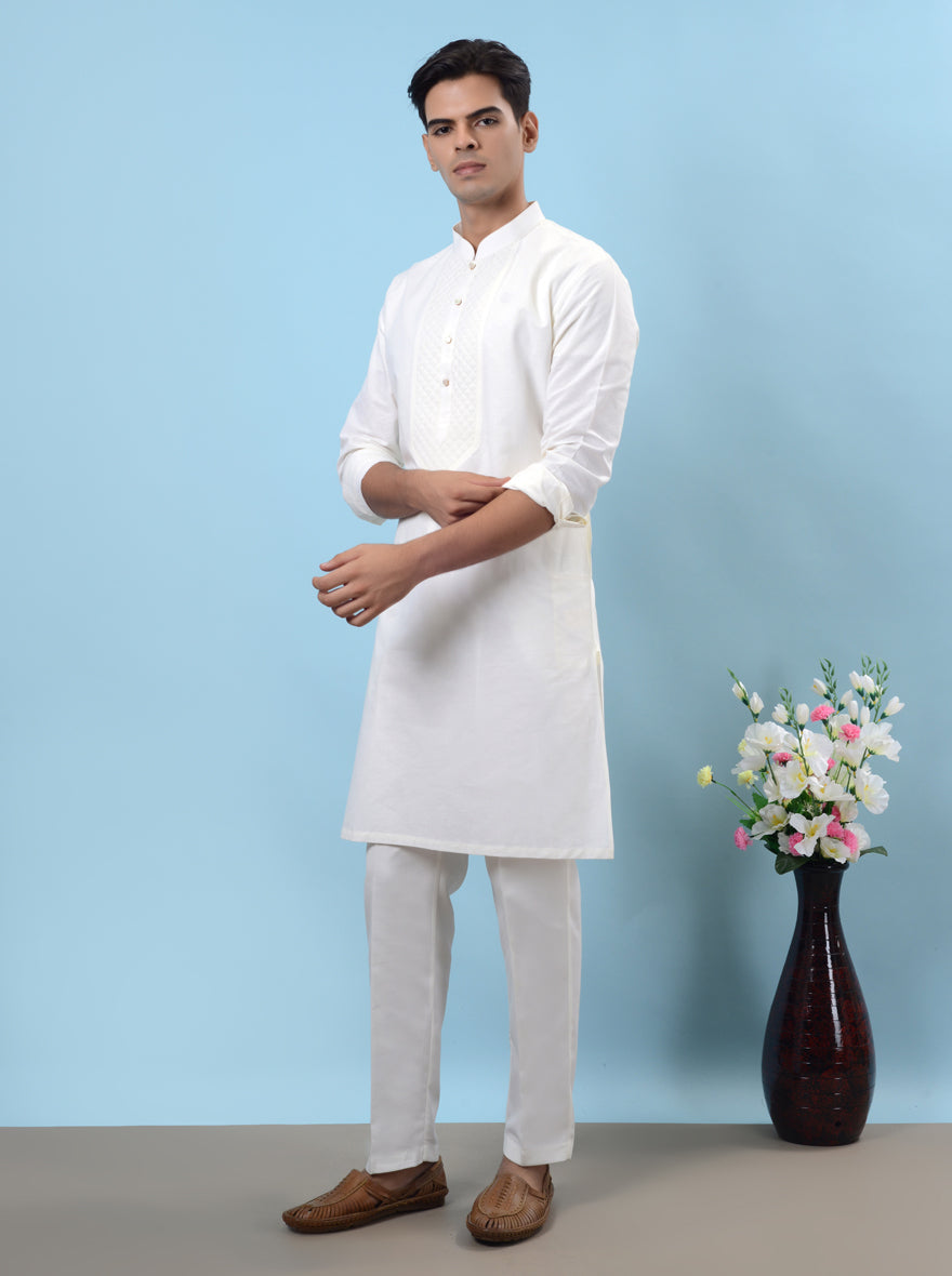 Elegant off-white cotton kurta pajama featuring embroidery, designed for comfort during festive occasions.