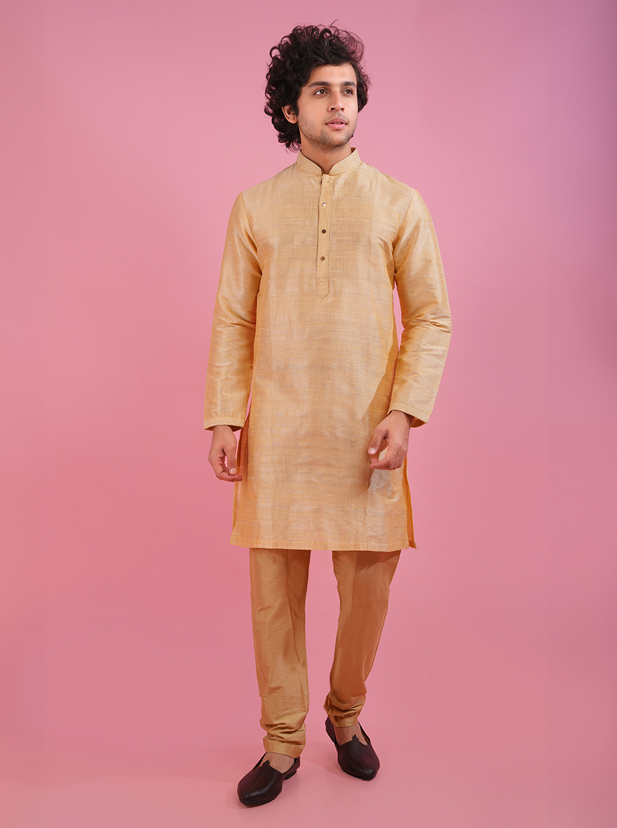 Elegant golden kurta pajama set made from silk blend, ideal for weddings and parties.