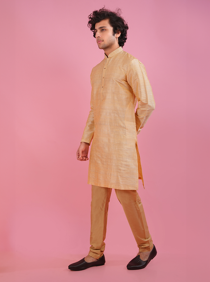 Shine brightly in this stylish golden silk kurta pajama at festive events.