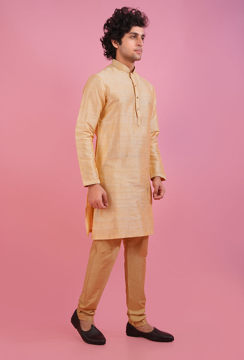 Elegant golden silk kurta pajama designed for festive occasions.