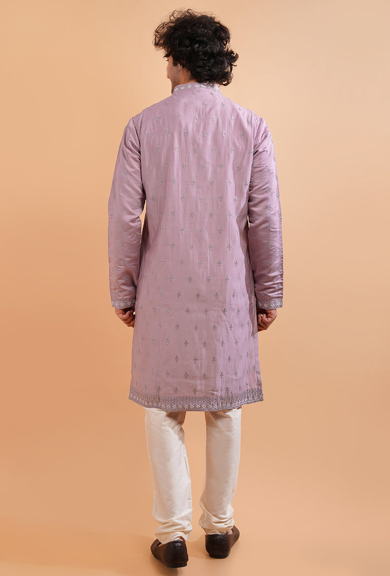 Men’s onion pink silk kurta pajama set with detailed embroidery, perfect for festive occasions.