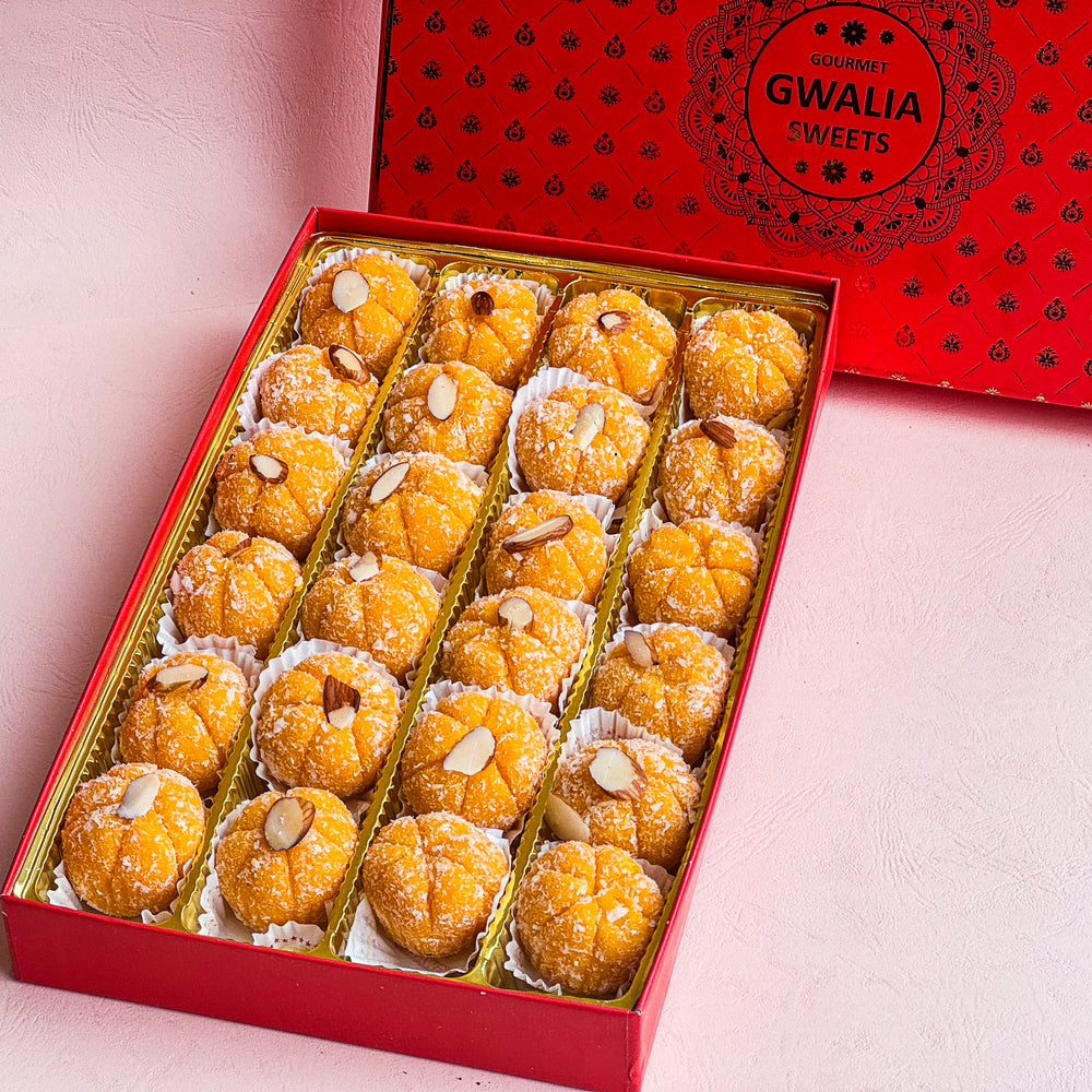 Savor the delightful fusion of zesty orange and smooth coconut in Orange Coconut Penda, a unique Indian mithai treat.