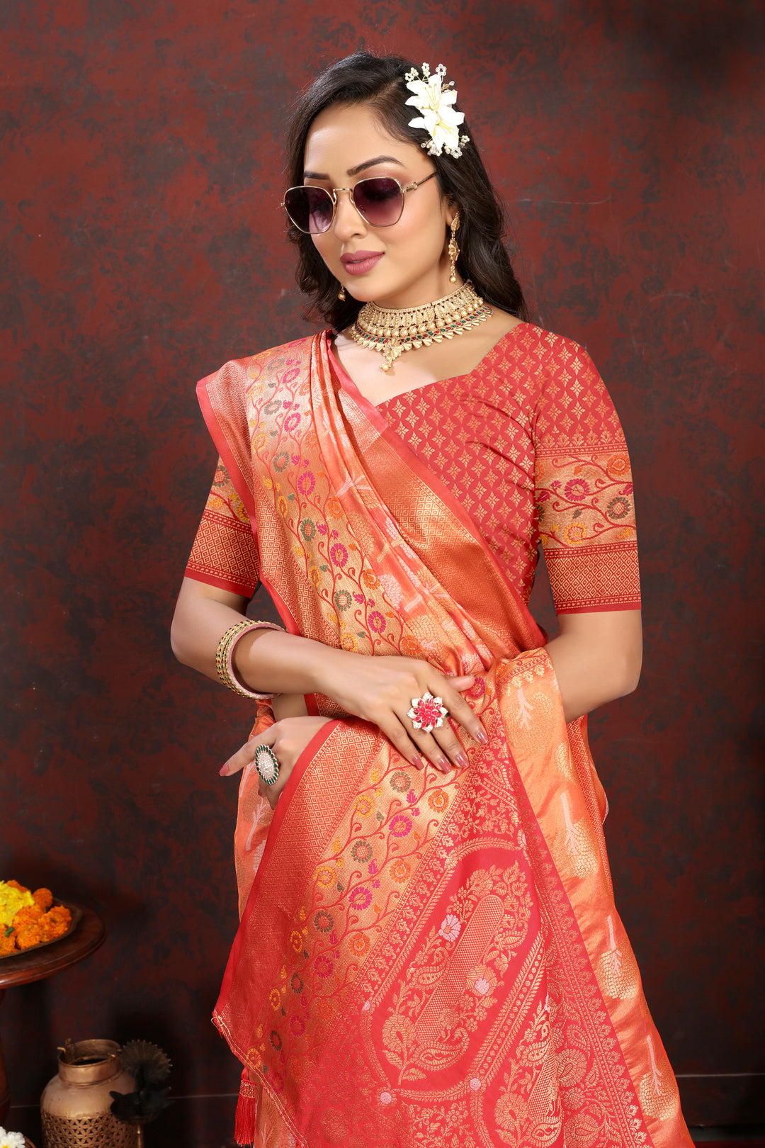 Classic orange Organza silk saree with rich Meenakari artistry, ideal for traditional occasions.