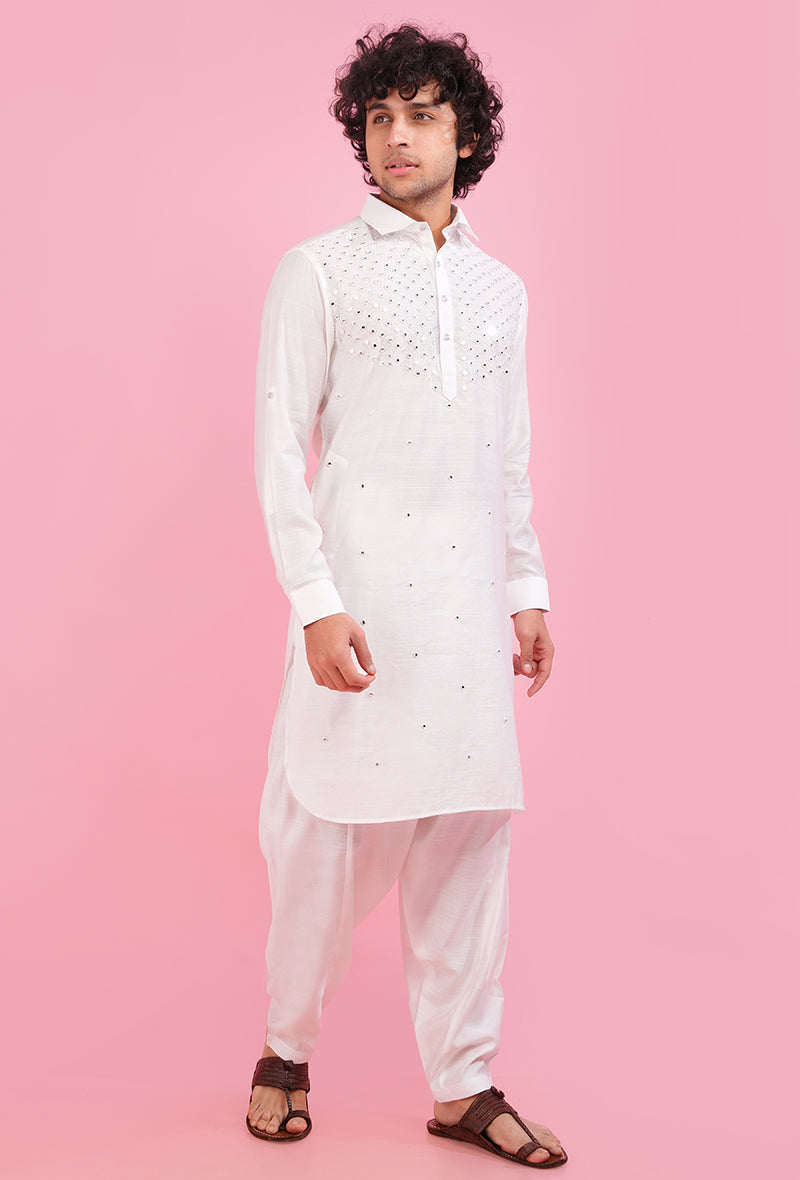 Celebrate tradition with style in this elegant white Pathani kurta, enhanced with luxurious resham and mirror embellishments, perfect for cultural events.