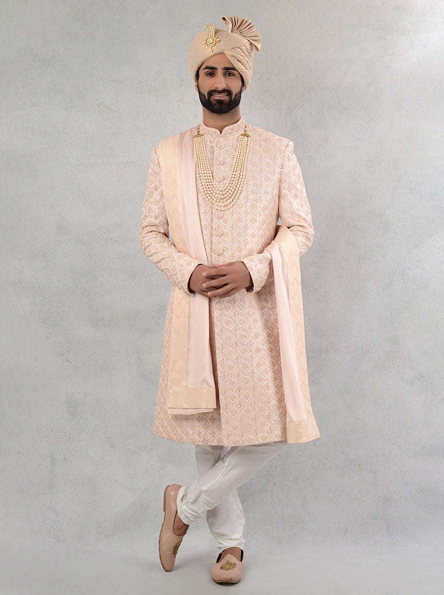 Celebrate your special day in style with this onion pink silk blend sherwani, showcasing delicate embroidery that enhances your wedding look.