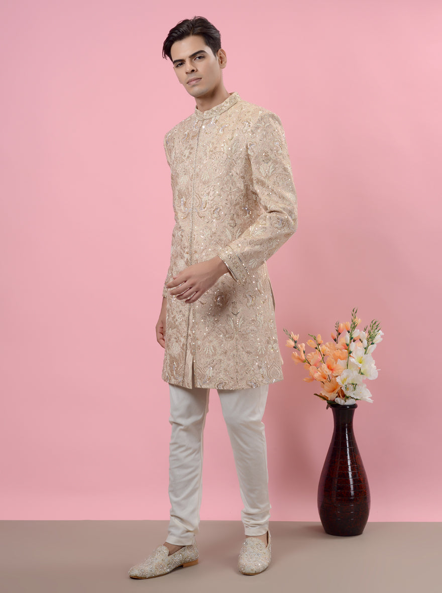 This elegant Beige Silk Embroidered Sherwani showcases intricate resham, sali, sequins, and beads.