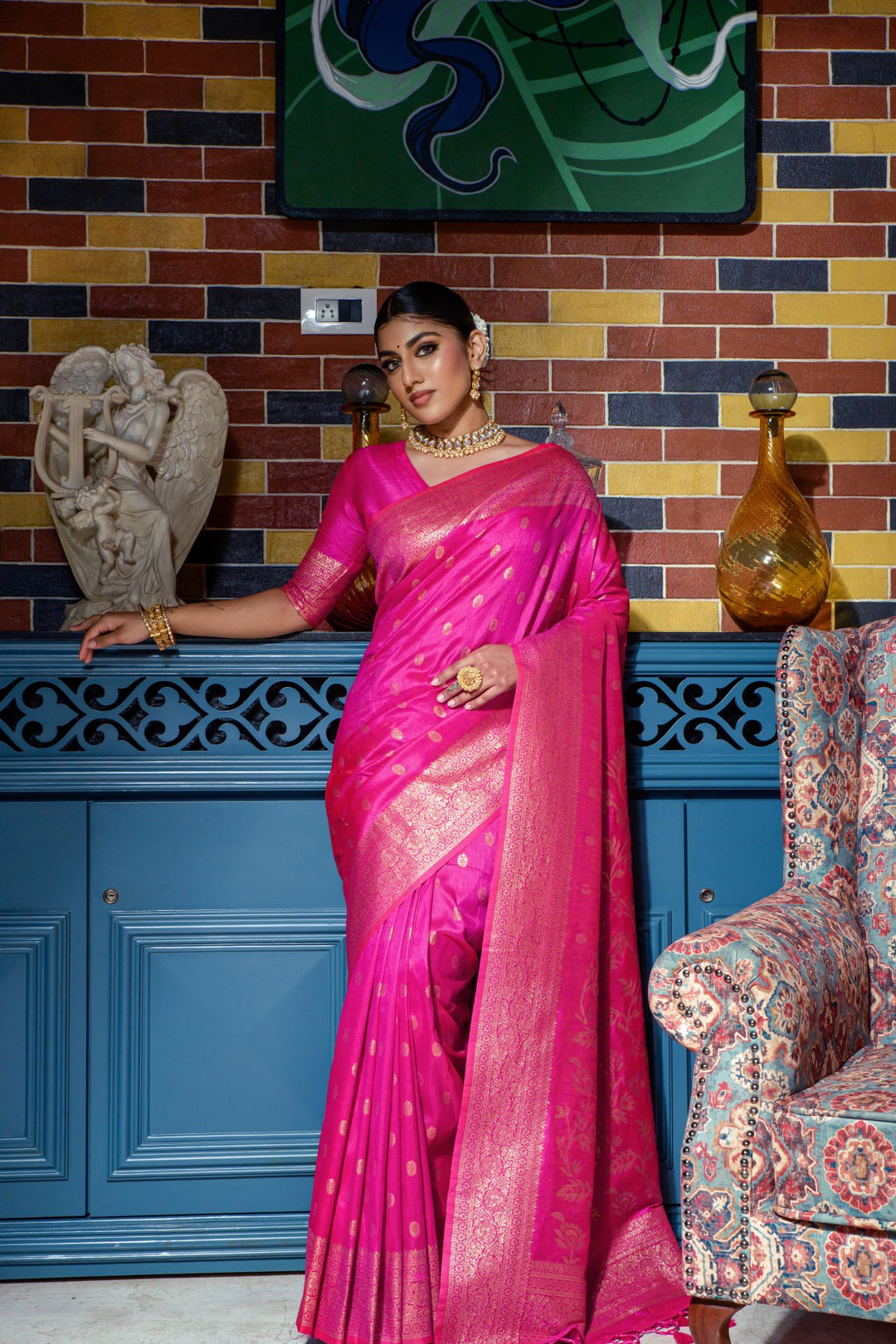 Traditional Bright pink Indian saadi featuring intricate zari weaving, luxury tassels, and a complete look for special occasions.