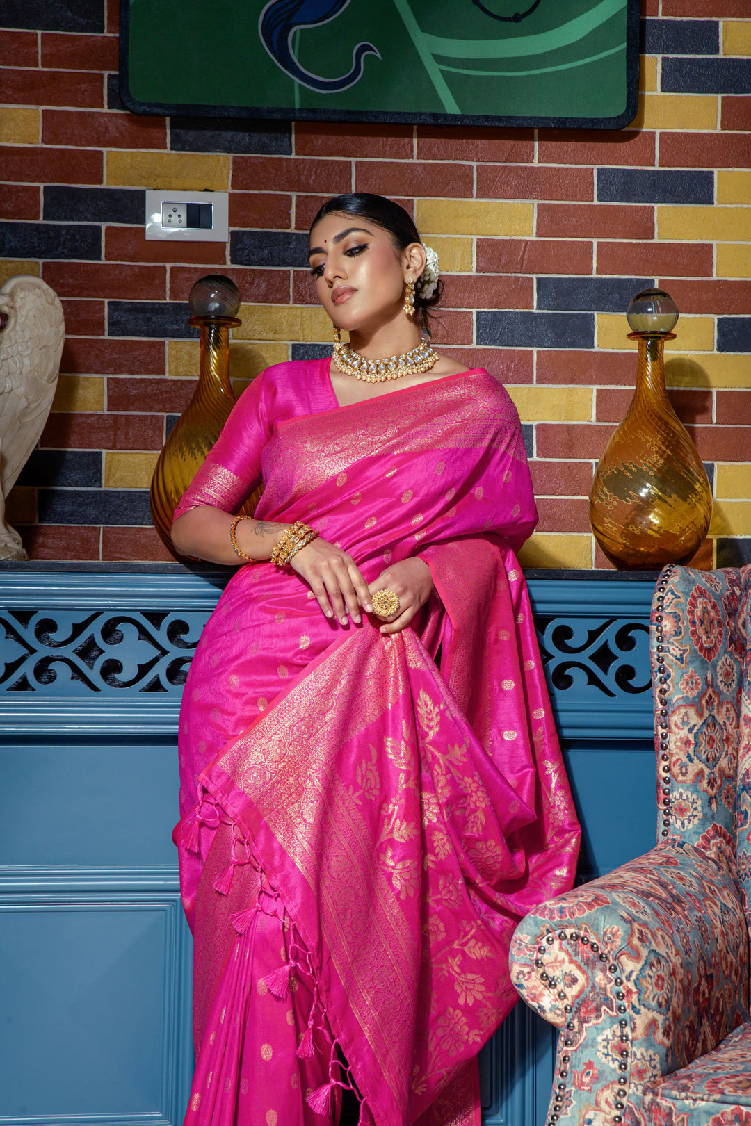 Stunning Bright pink saree with intricate zari work, tassels, and a beautiful border, ideal for any cultural or festive occasion.