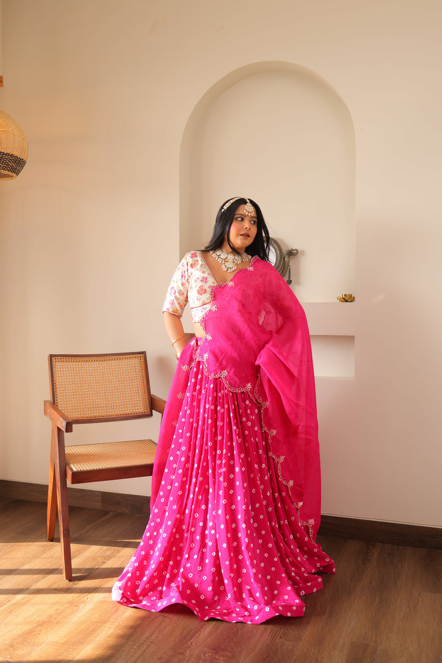 Beautiful Raani Bandhej Banarasi lehenga in pink, paired with a stylish organza dupatta for a luxurious ethnic ensemble.