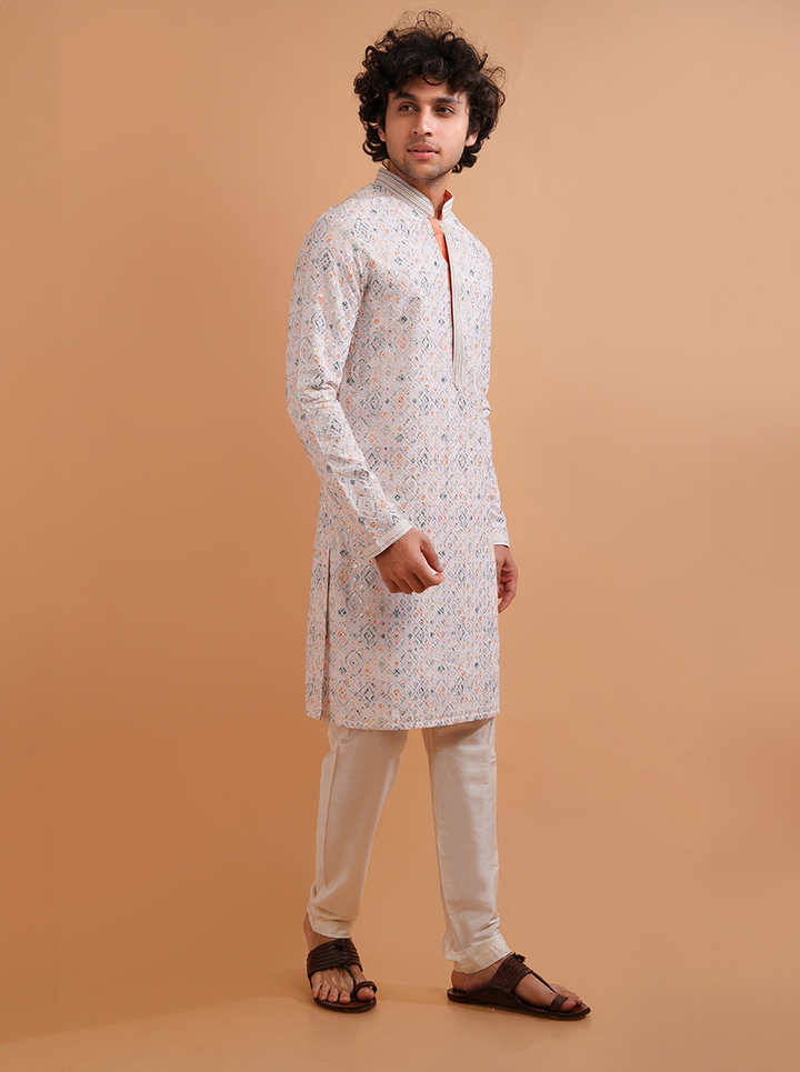 White silk blend men's kurta pajama set, featuring intricate embroidery for a classic look.