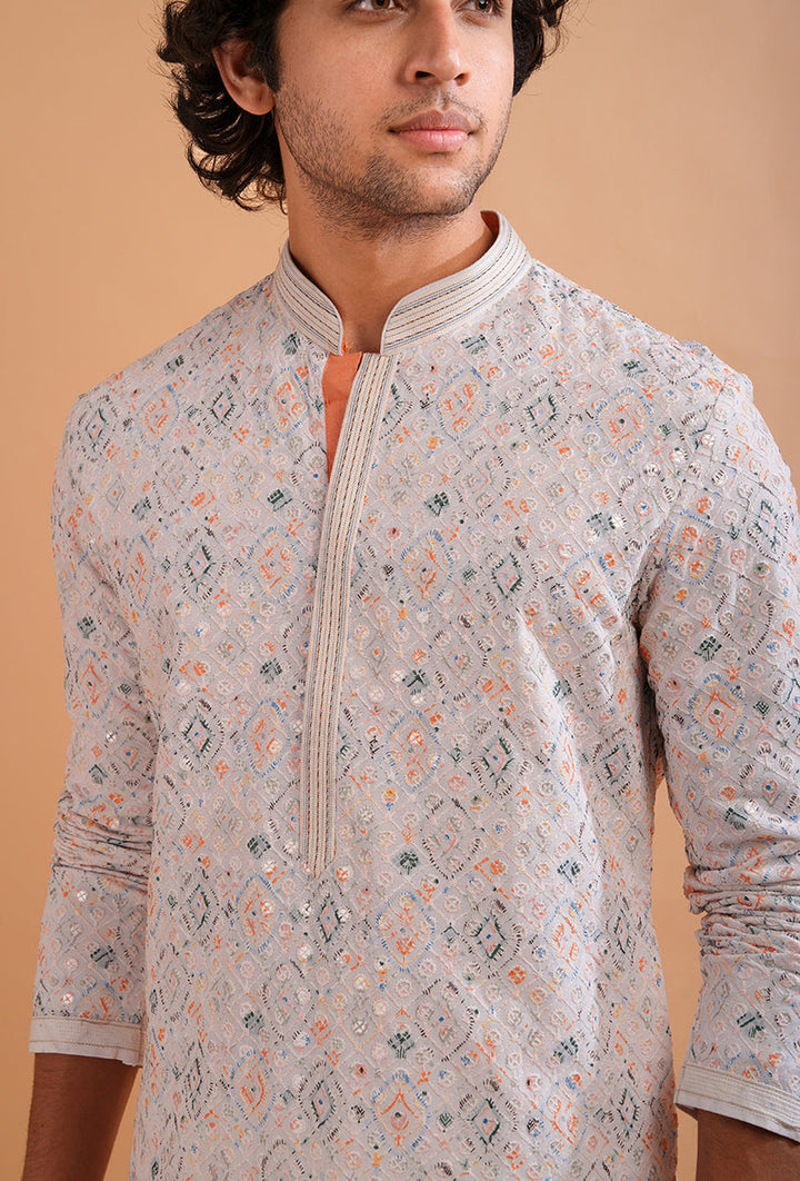 Stylish white silk blend kurta pajama set for men with delicate embroidery for festive occasions.