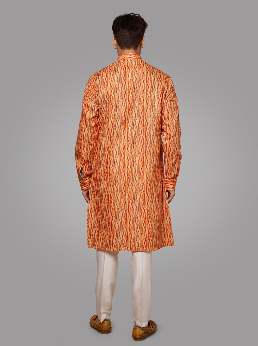 Stand out in this orange kurta pyjama, designed with intricate embroidery for weddings and festivities in the USA.