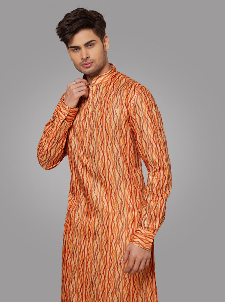 Men’s orange silk kurta pajama set with embroidered design, ideal for traditional celebrations and festive occasions.