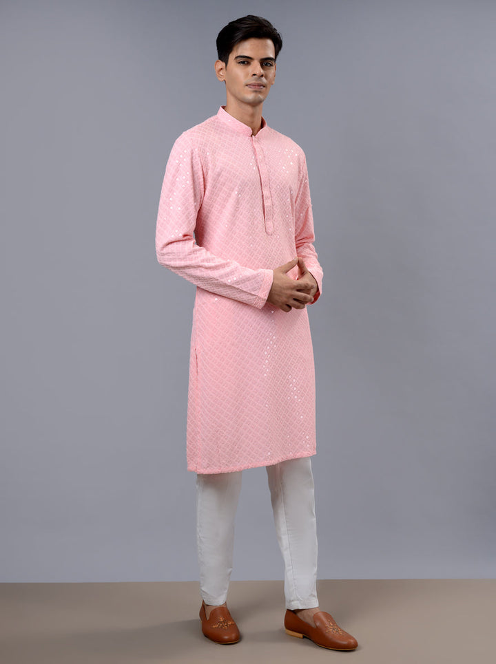 Luxurious pink kurta pajama featuring detailed embroidery, perfect for memorable celebrations.