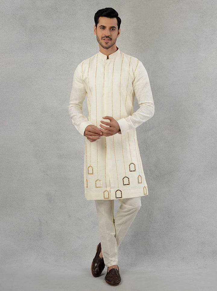 Cream cotton kurta pajama for men, adorned with exquisite embroidery.