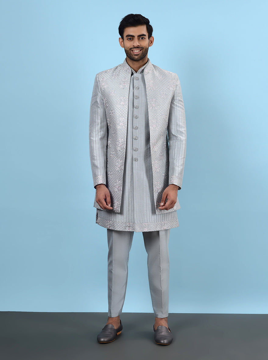 Celebrate in style at your gruh shanti in the USA with this elegant Grey Indowestern, made from high-quality silk blend and adorned with intricate embroidery for a lovely look.