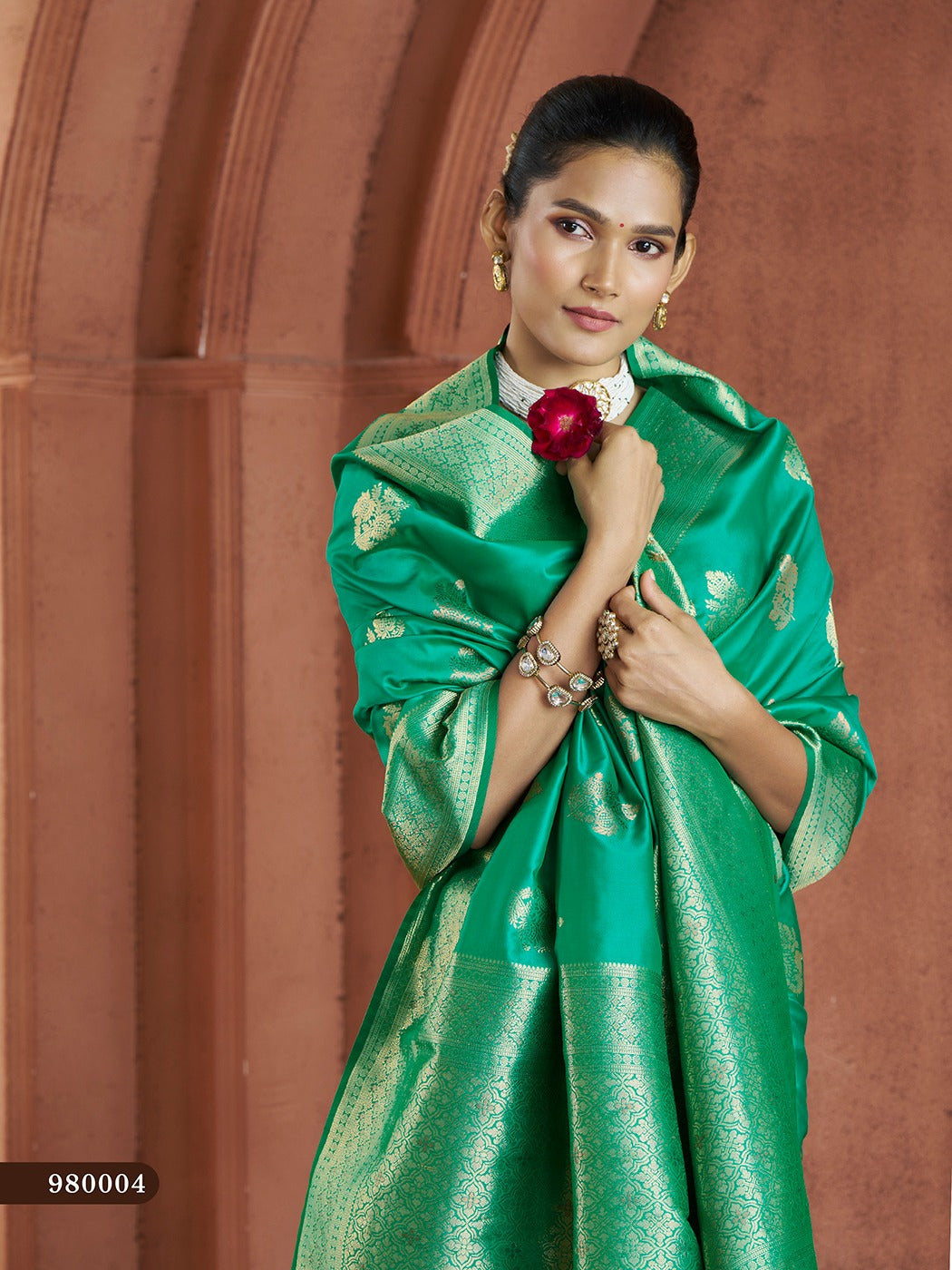 Elegant green Banarasi saree with luxurious silk blouse, perfect for bridal wear.