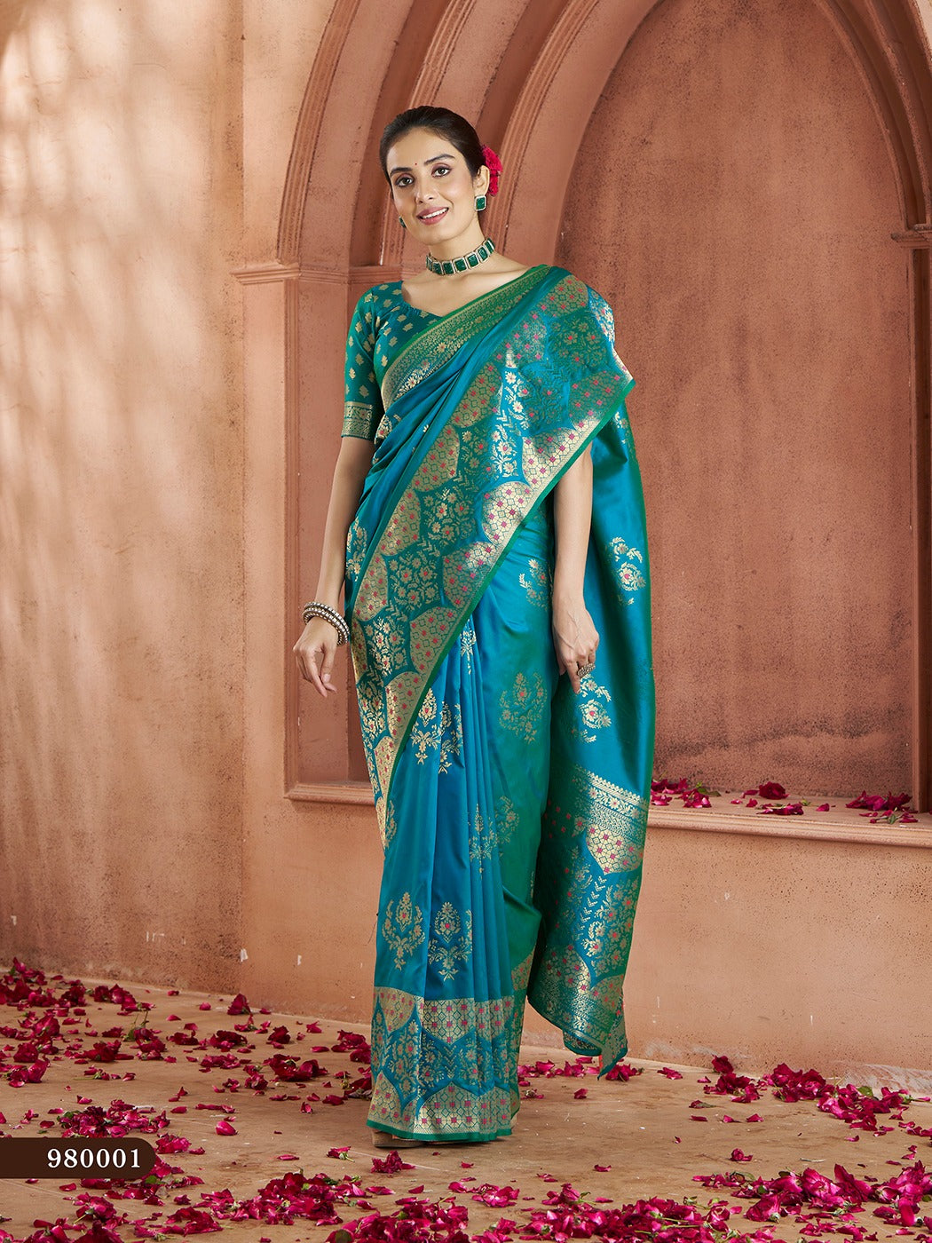 Traditional teal-blue Banarasi saree with woven gold accents, ideal for festive occasions.