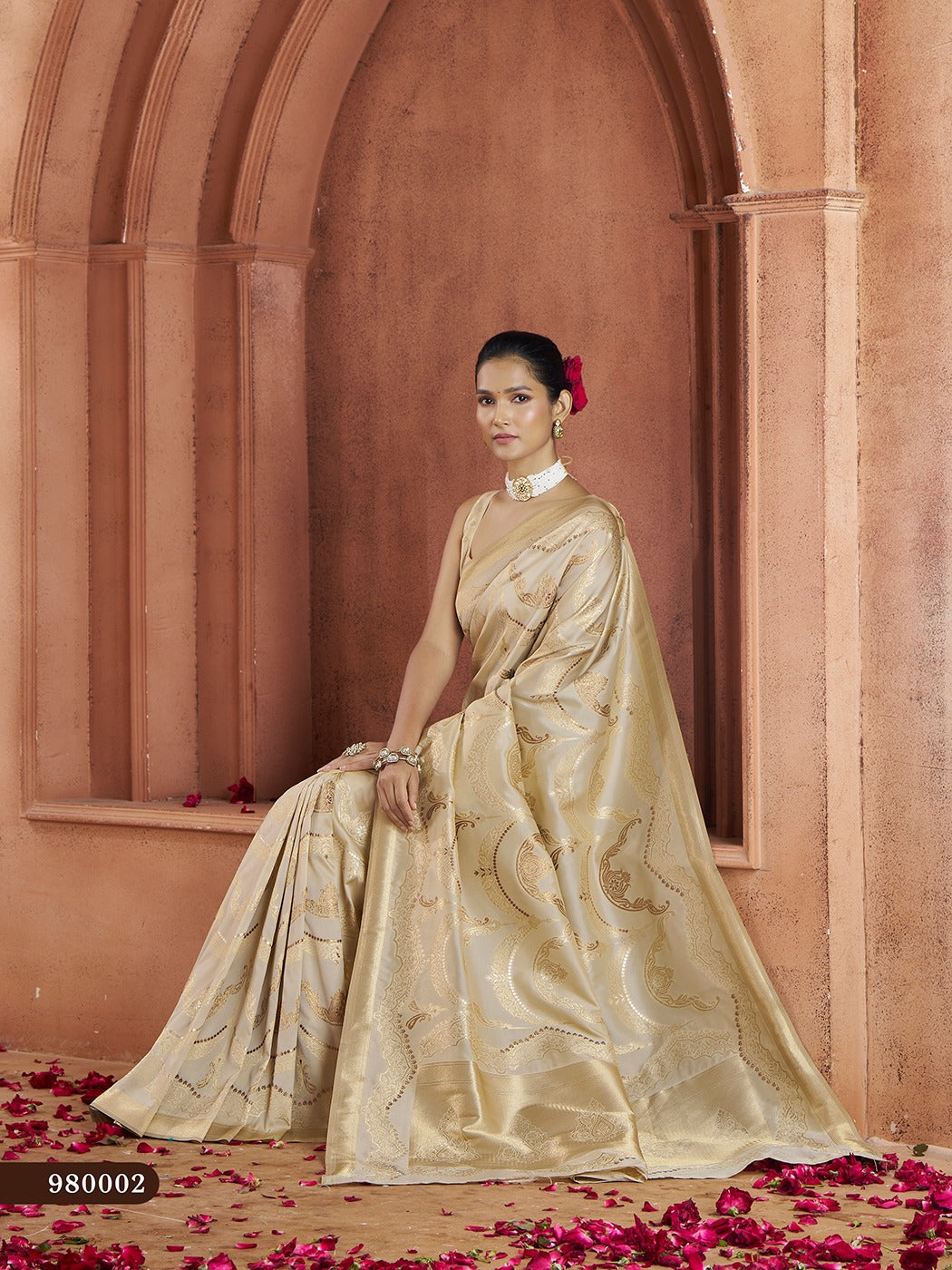 Graceful cream Banarasi saree with intricate woven patterns, perfect for bridal wear.