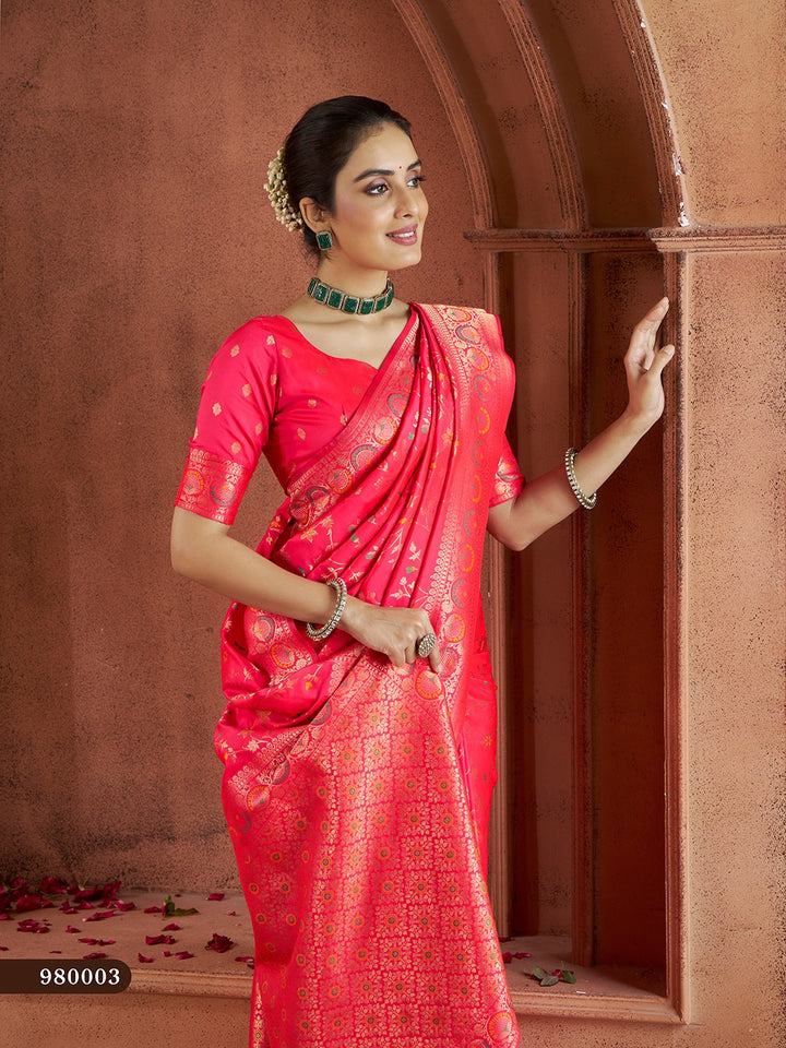 Elegant bright-pink Banarasi saree with luxurious gold thread work, ideal for bridal wear.