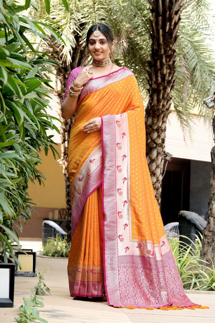 Traditional Orange saree with Banarasi fabric, peacock border, zari pallu, and fancy tassels. Ideal for weddings and cultural events.