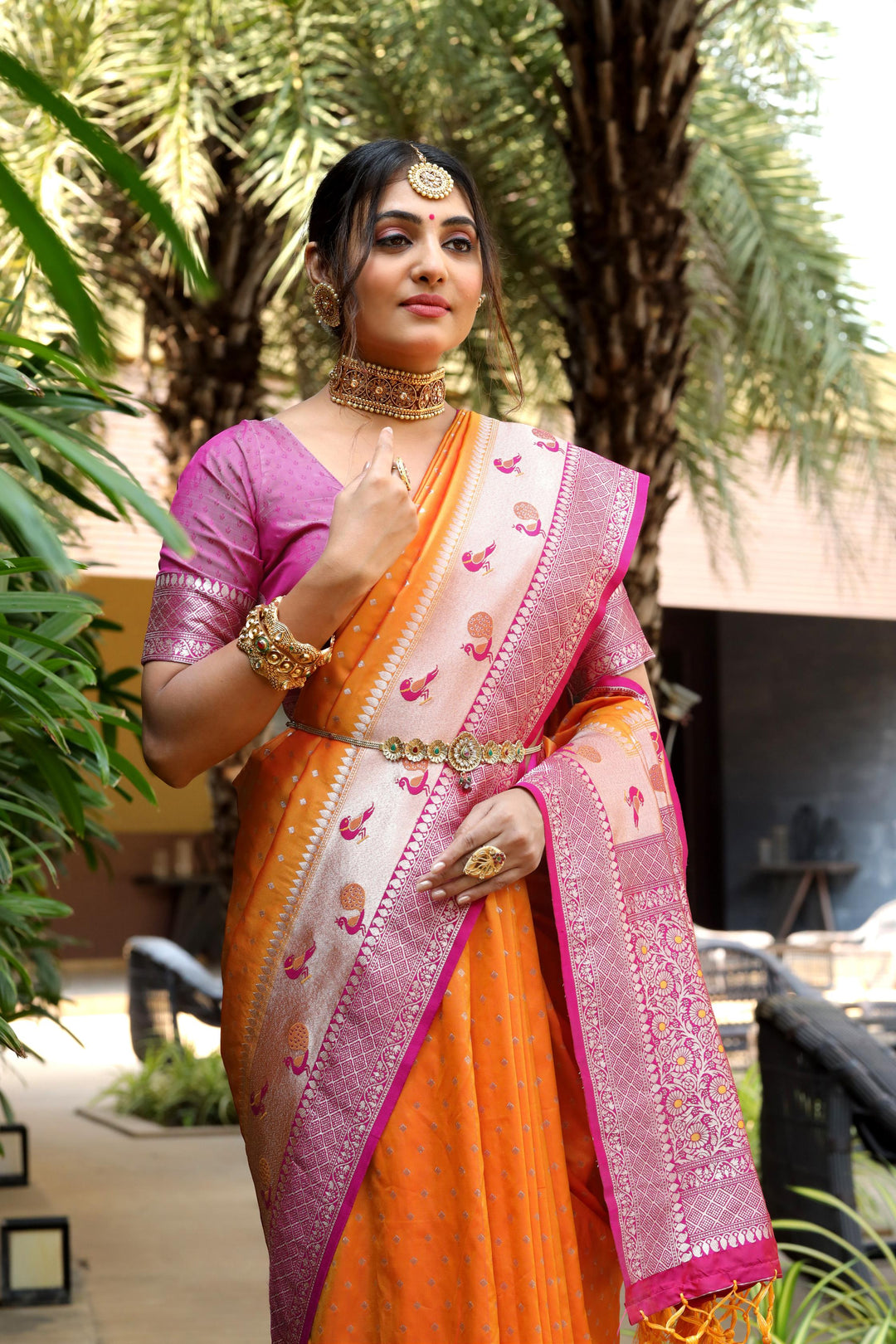 Latest Orange saree with a beautiful Banarasi weave, contrast peacock border, and zari pallu. Ideal for weddings and other traditional events.