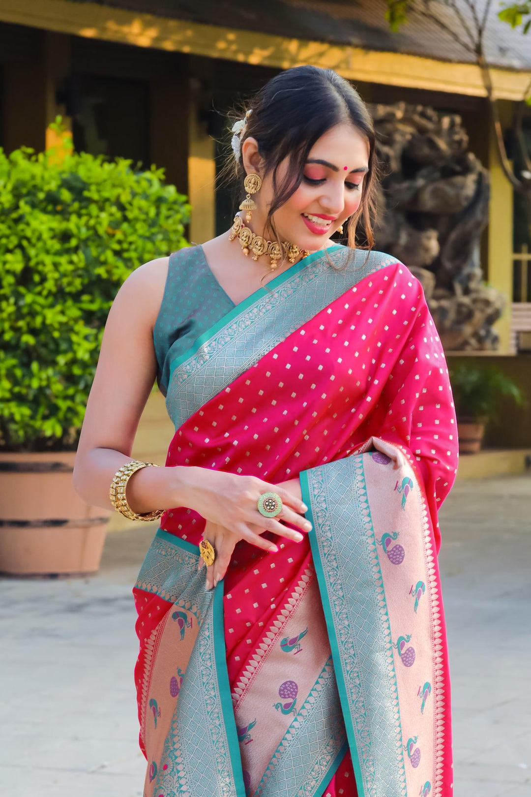 Luxurious Bright pink designer saree with contrast peacock border and zari pallu. Ideal for weddings, festivals, or any traditional event.