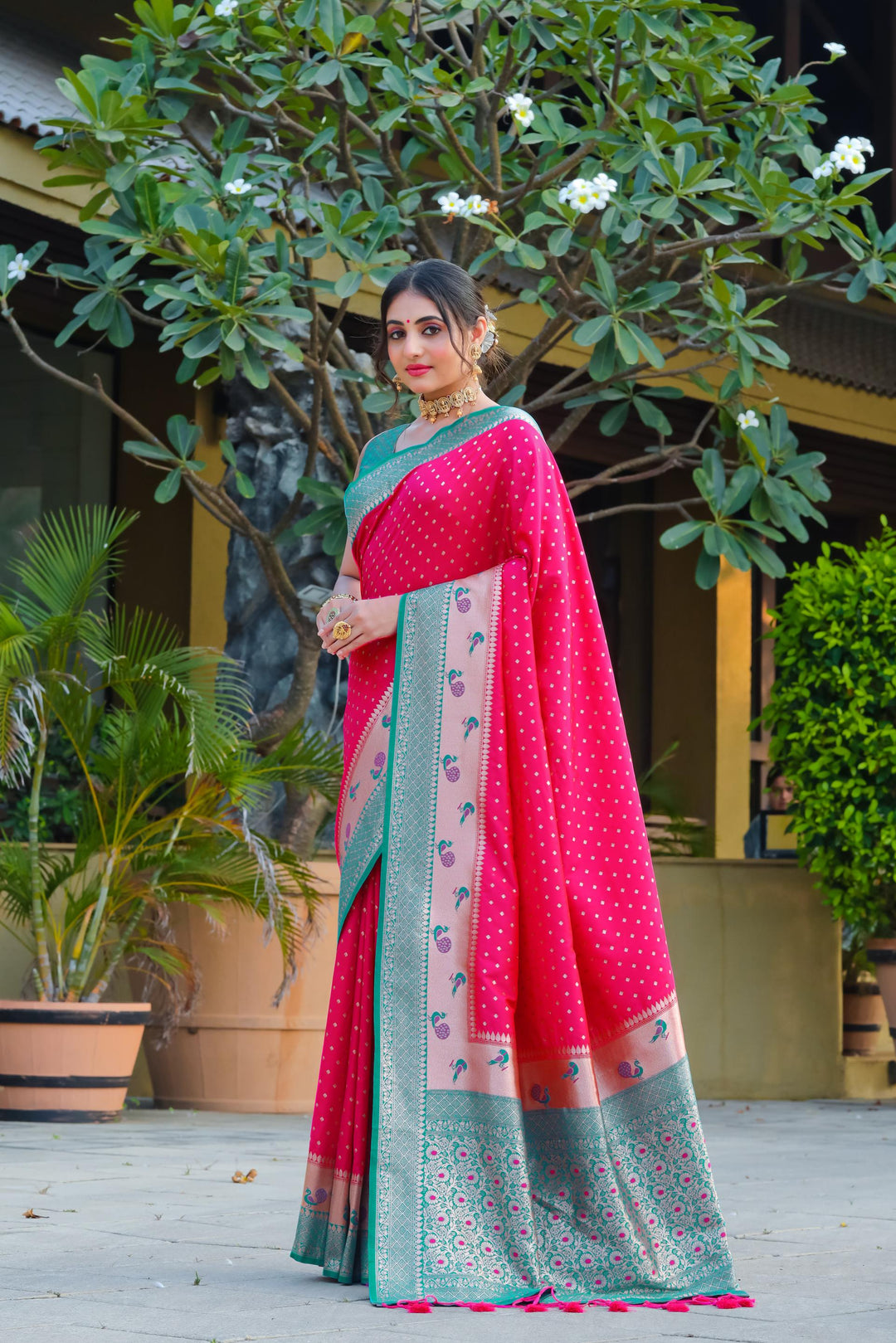 Bright pink Indian wedding saree featuring Banarasi, peacock border, and zari pallu. Add elegance to your special occasion with this stunning piece.