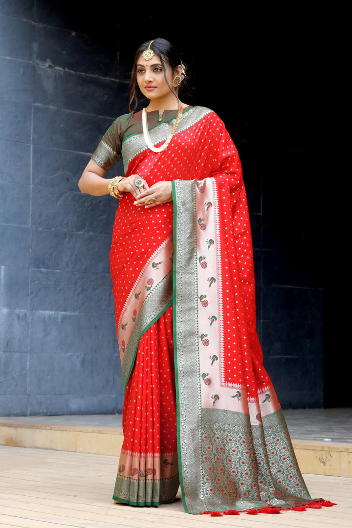 Red Banarasi saree with peacock border, zari pallu, and fancy tassels. Ideal for special occasions like weddings and cultural events.