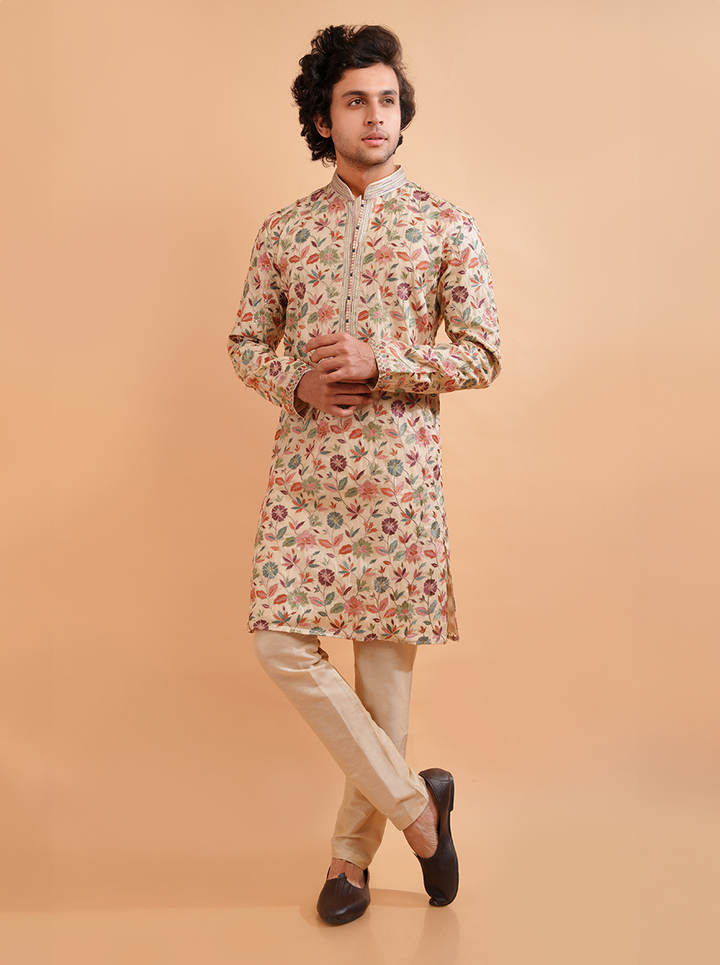 Elegant cream kurta pajama set for men with intricate resham embroidery, perfect for weddings.