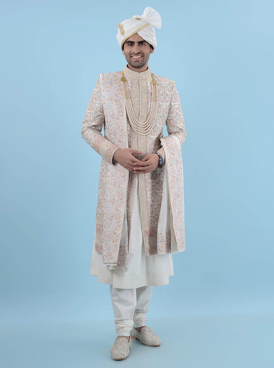 Experience the essence of modern sophistication with this Cream Multi Sherwani, designed for grooms in the USA and featuring exquisite embroidery on luxurious silk fabric, ensuring you look unforgettable at your wedding.