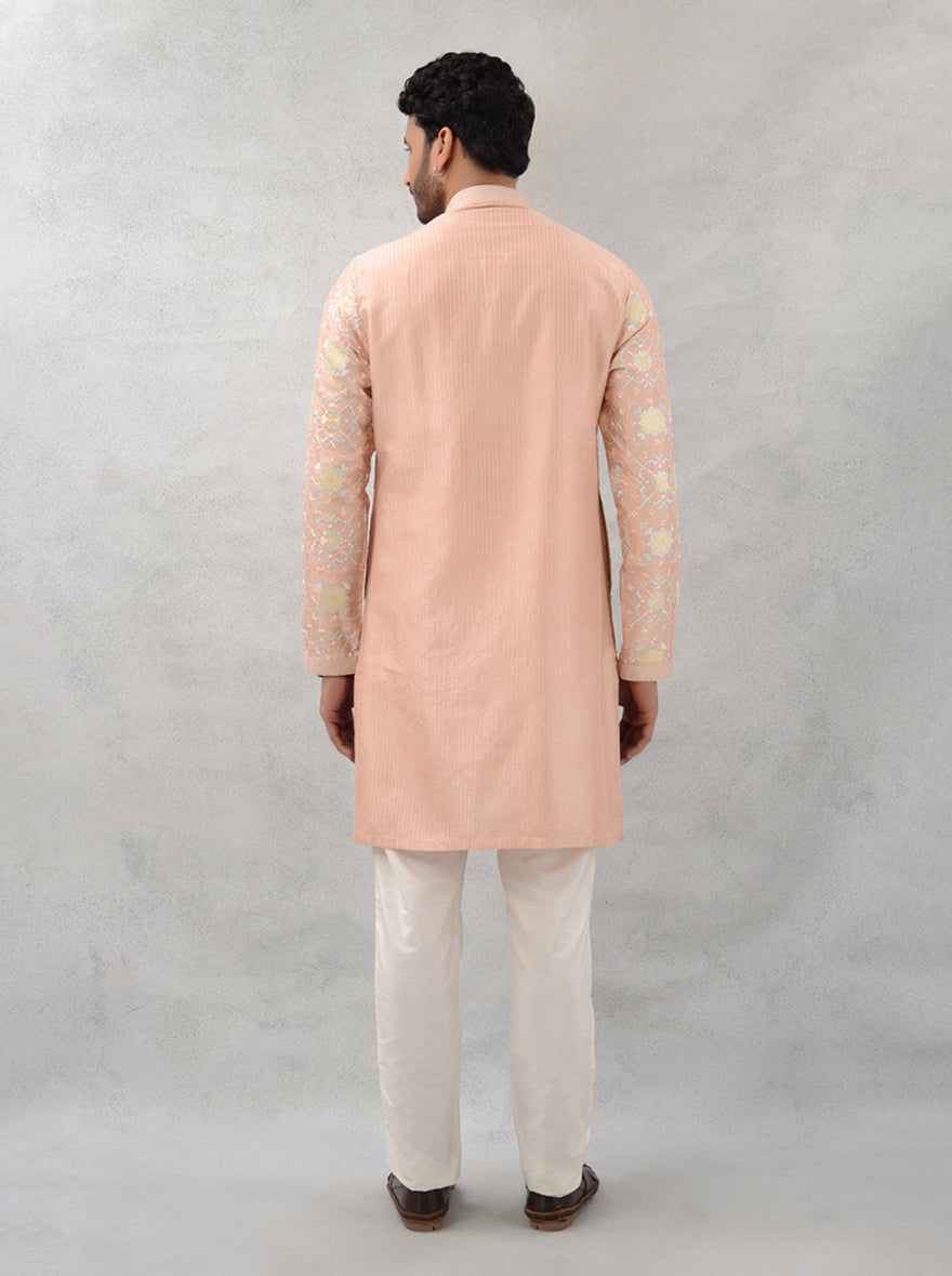 Celebrate in style with this peach kurta pajama, showcasing exquisite embroidery for modern men in the USA.