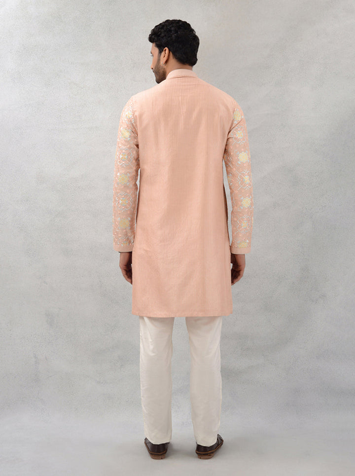 Celebrate in style with this peach kurta pajama, showcasing exquisite embroidery for modern men in the USA.