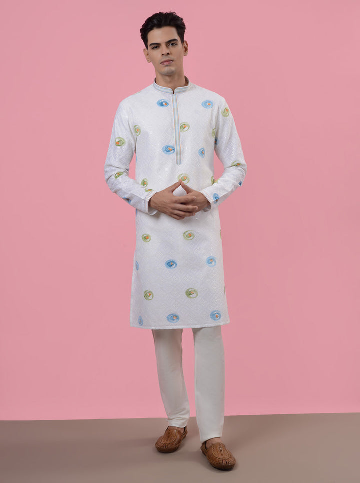 Unique white silk kurta pajama designed for stylish men attending wedding celebrations.