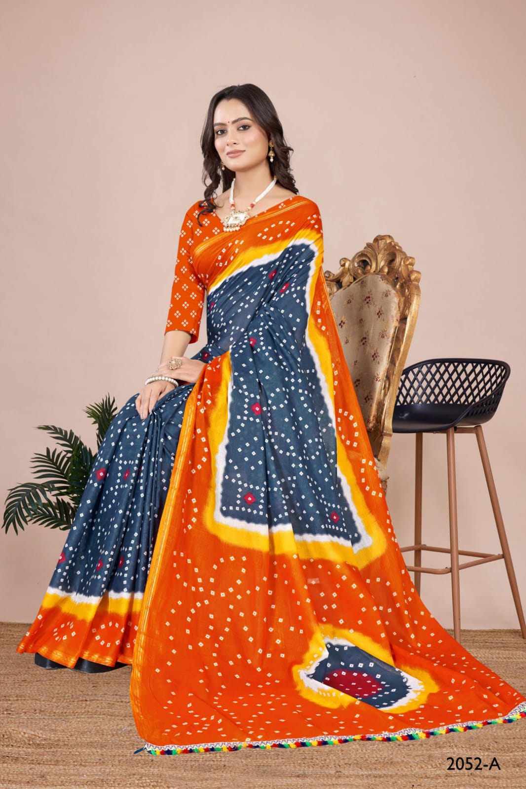 Chic grey Indian wedding saree with a vibrant tie-dye Bandhani design, perfect for special occasions.