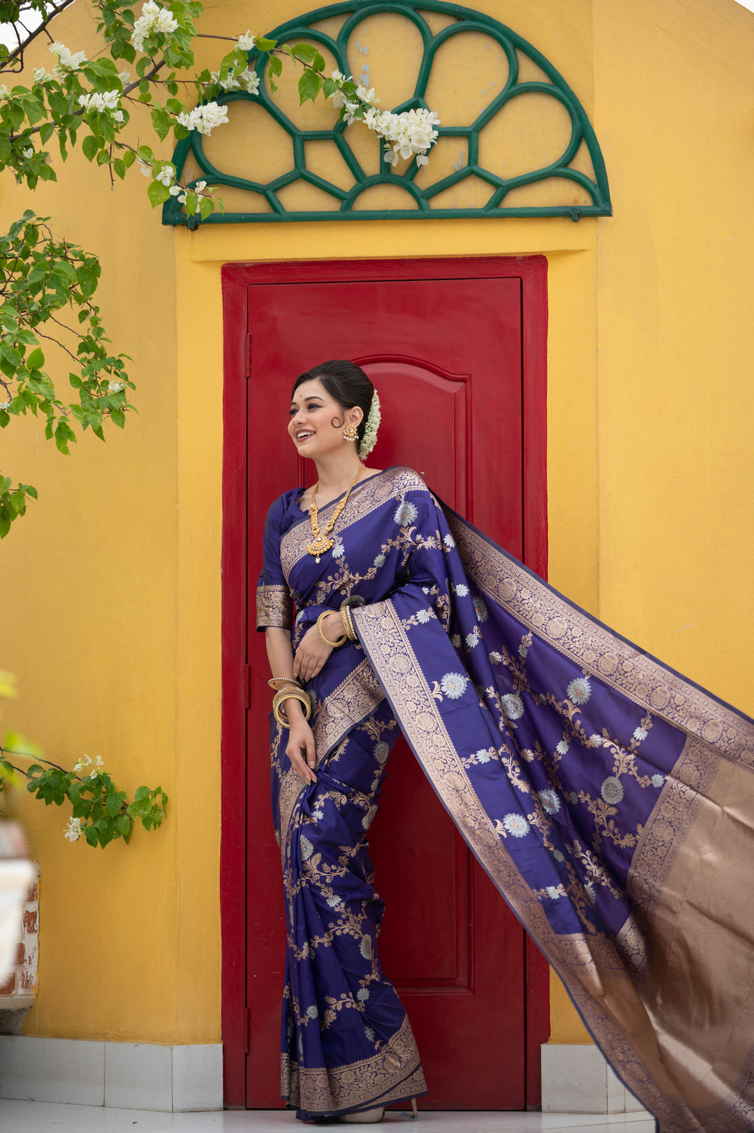 Sophisticated Soft Banarasi Katan silk saree with a beautiful weaving pallu and decorative tassels.