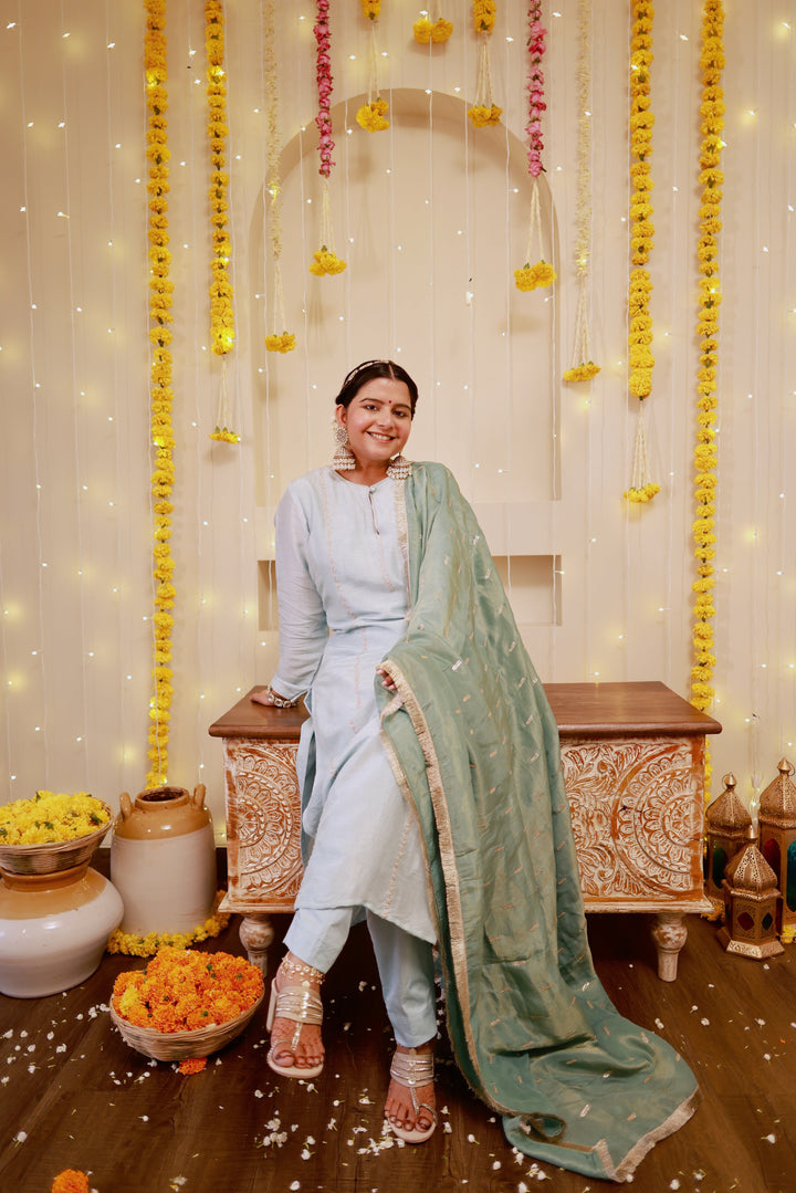 Chic ice blue kurta pajama ensemble with a contrasting sage green dupatta, ideal for traditional events and celebrations.