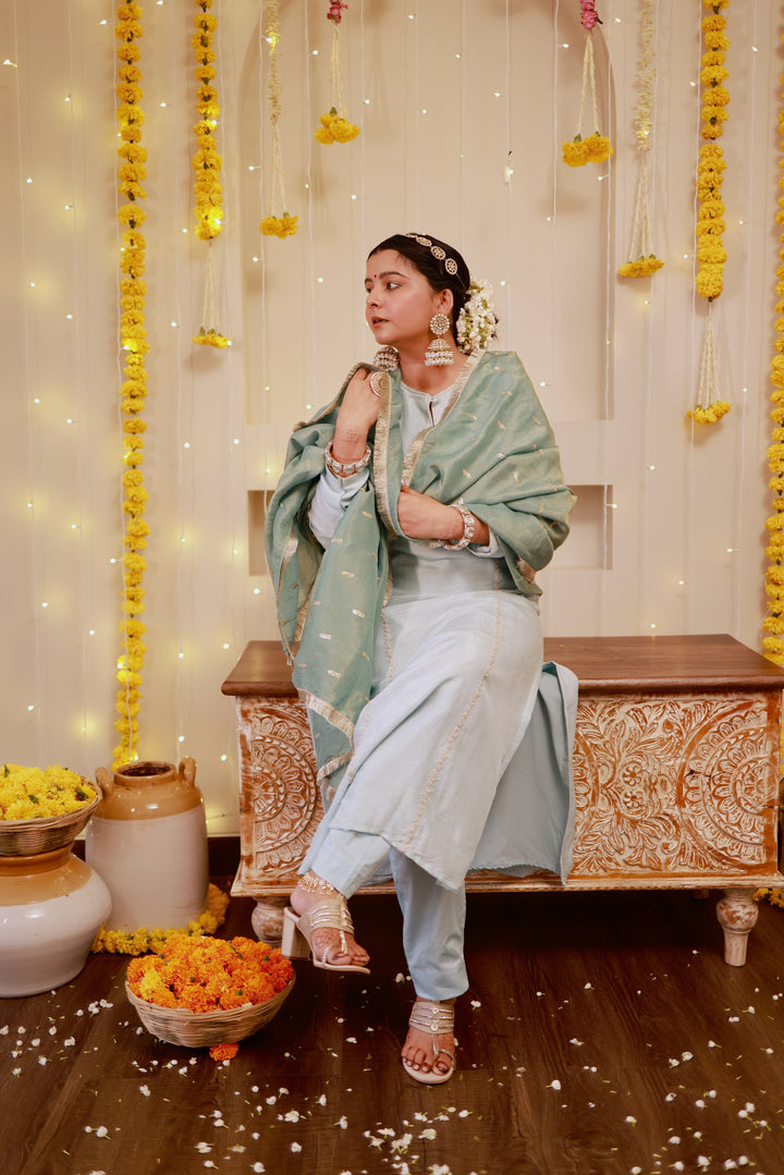 Sophisticated ice blue kurta pajama outfit paired with a sage green dupatta, perfect for weddings and festive gatherings.